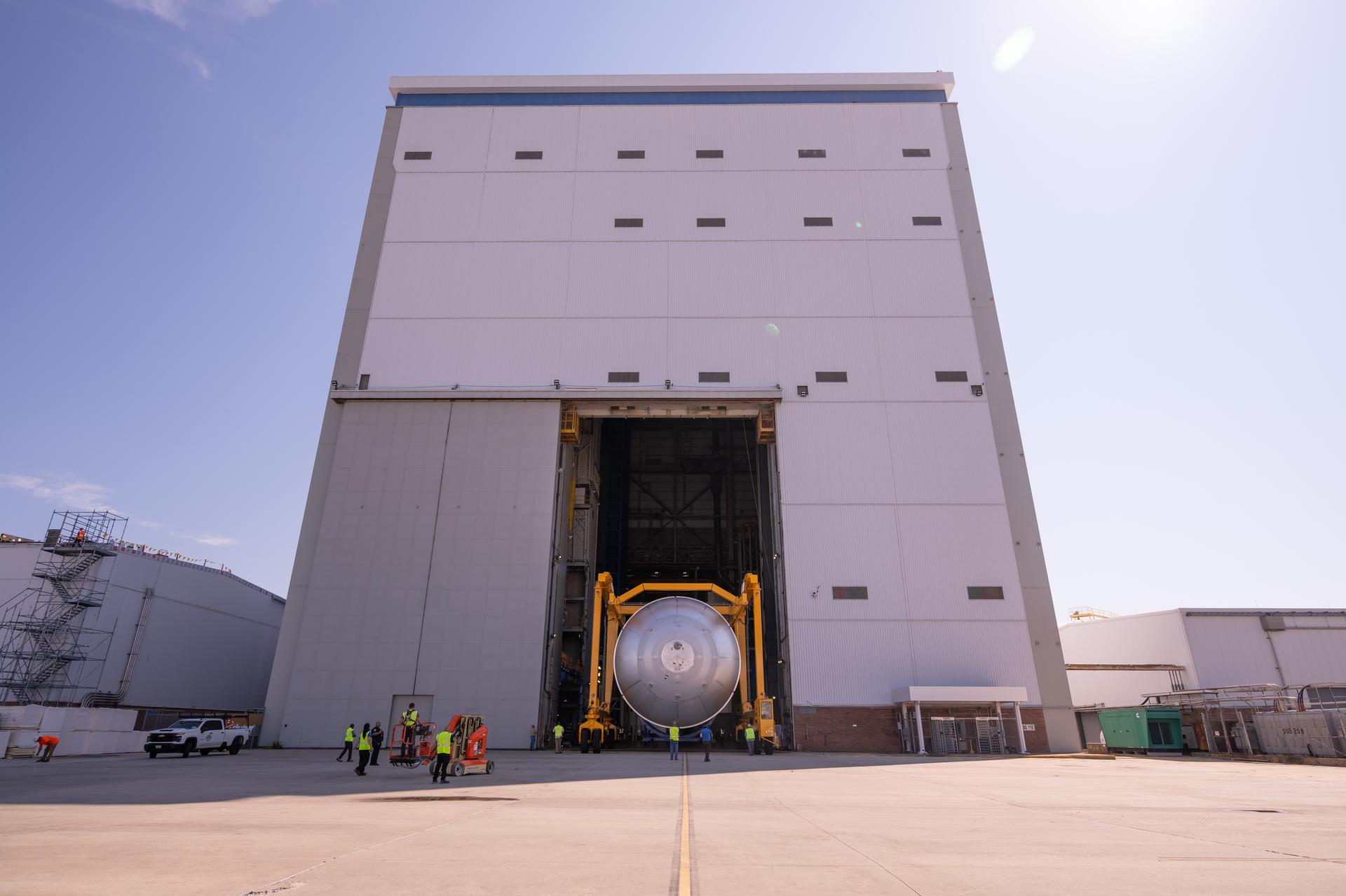 Teams at NASA’s Michoud Assembly Facility in New Orleans move a liquid oxygen tank from the main rocket factory into the adjacent vertical assembly building. The liquid oxygen tank, which will form part of the SLS (Space Launch System) rocket for NASA’s Artemis IV mission to the Moon, is rotated from a horizontal to a vertical configuration and loaded into the high bay’s hydrostatic proof testing cell. This non-destructive evaluation method tests the structural integrity of the tank’s welds by filling the tank with water, simulating the propellant used during launch. The propellant tank will hold more than 196,000 gallons of super-cooled liquid oxygen at launch and is one of five major elements that make up the 212-foot-tall SLS rocket stage. The core stage, along with its four RS-25 engines at its base, produces more than two million pounds of thrust to help launch NASA’s Orion spacecraft, astronauts, and supplies beyond Earth’s orbit and to the lunar surface for Artemis.